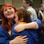 Sabina Karwowski, left, hugs her friends, Becca Seneff, after Homer High School graduation on Tuesday.