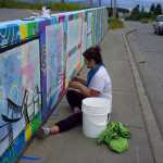 Kady Perry works on the Heath Street mural last Friday.