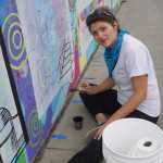Kady Perry works on the Heath Street mural.