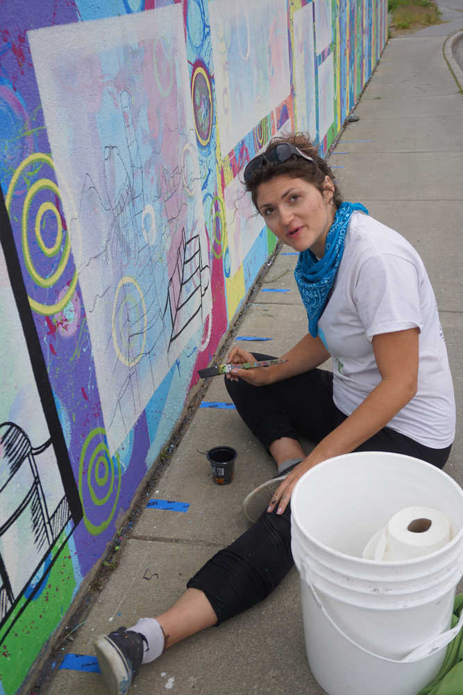 Kady Perry works on the Heath Street mural.