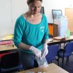 Dr. Sarah Spencer of South Peninsula Hospital refills a safer injection kit, which includes supplies for sterile injection of intraveneous drugs such as syringes, disposable cookers, sterile water, alcochol pads and bandages.
