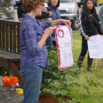 Tina Seaton reads a name of one of the Pulse night club victims last Friday at a memorial at WKFL Park.