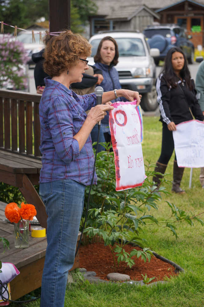 Tina Seaton reads a name of one of the Pulse night club victims last Friday at a memorial at WKFL Park.