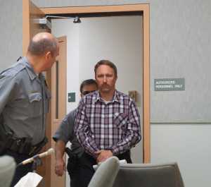 Stephen R. Boyle is lead into the Homer Courthouse about 11 a.m. Friday, June 17, 2016, in Homer, Alaska. Boyle was arraigned on six counts of first-degree sexual abuse of a minor. He is the deputy chief for Kachemak Emergency Services.