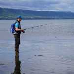 Oistein Stokke Berget of Trondheim, Norway, tries his luck fishing for kings on the beach outside the Nick Dudiak Fishing Lagoon on Sunday.