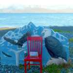 The Red Chair rests on the Homer Spit beach by the Jean Keene memorial at Land's End Resort.