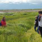 Carmen Field, left, speaks to a group of about 30 visitors on an Estuary Walk tour in July 2011.-Homer News file photo