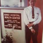 A photo shows Dr. John B. Fenger, Homer's first resident doctor, posing for a picture in front of the Homer Hospital Health Center.