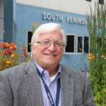 South Peninsula Hospital CEO Robert Letson poses for a photo in front of the hospital's Bartlett Street entrance. The same spot will host a town photo taken by a drone at 1 p.m. on Saturday, July 9 during SPH's 60th Anniversary Party.