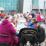 Crowds of Homer residents gathered at long tables in the Bartlett Street parking lot of South Peninsula to enjoy a barbecue lunch provided by Black Jaxx BBQ for the July 9 South Peninsula Hospital 60th Anniversary celebration.