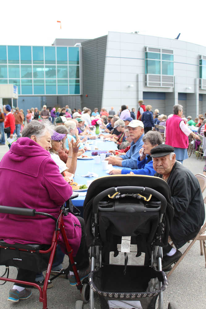 Crowds of Homer residents gathered at long tables in the Bartlett Street parking lot of South Peninsula to enjoy a barbecue lunch provided by Black Jaxx BBQ for the July 9 South Peninsula Hospital 60th Anniversary celebration.