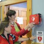 Samantha Cunningham, right, helps Bobby News decide on a location for a public automatic external defibrilator at the Anchor Point Senior Center. Cunningham is the Kenai Peninsula Borough Emergency Medical Services coordinator and Ness is president of the senior center board. Cunningham helped get a $43,000 grant from the Tesoro Foundation to install AEDs in public places on the peninsula, including Anchor Point.-Photo by Michael Armstrong, Homer News