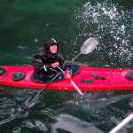 Kayak guide Kim McNett kayaks in Peterson Bay near the Alaskan Coastal Studies Peterson Bay Station in July 2014.