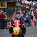 Rep. Paul Seaton, R-Homer, rides a scooter in the Homer Fourth of July Parade.