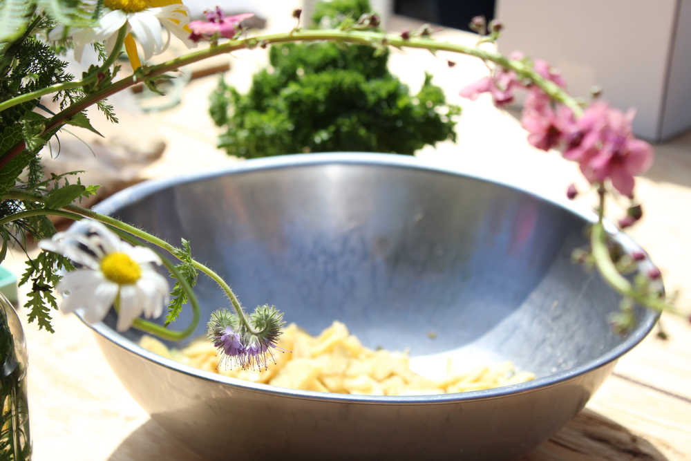 Guests at the First Annual Great Garlic Scape Festival at Synergy Gardens learned how to pickle ginger from Homestead Restaurant Chef Richard Nell. Fresh flowers from the farm adorned the tables at the festival.
