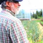 Wayne Jenkins gives a tour of one of the high tunnels at Synergy Gardens during the First Annual Great Garlic Scape Festival. The Jenkins have two high tunnels on their property where they grow a variety of produce.