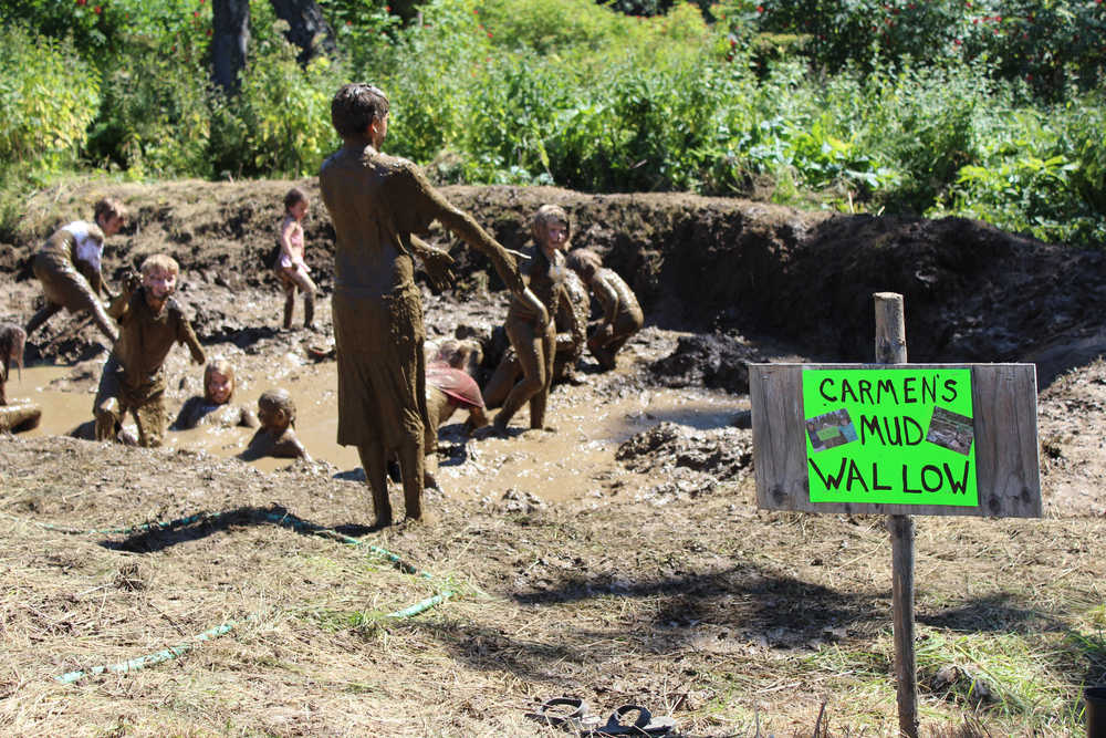 Homer kids and adults wade in the mud on July 17, finding relief from the warm temperatures that reached the high 60s. The 2016 Mud Wallow at Cottonwood Park honored Carmen Field, who helped found Nature Rocks and facilitated the Mud Wallow along with other Homer residents as a way to get kids outdoors.