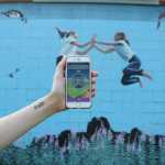 The mural on the side of Healing Hands Massage off East End Road is located conveniently next to a gym.