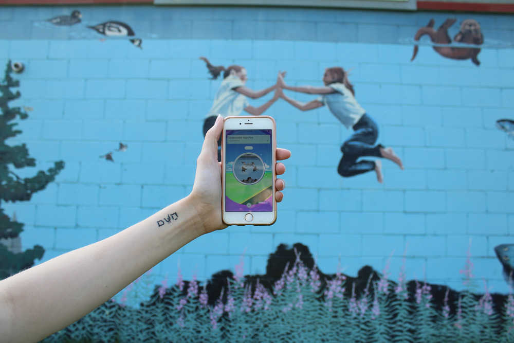 The mural on the side of Healing Hands Massage off East End Road is located conveniently next to a gym.