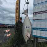 David Pudlosky poses with the 246-pound halibut he reeled in on July 25 while fishing with Inlet Charters. The fish is large enough to bump the current derby leader out of first, however, the Mountain Top, PA, man did not have a derby ticket.