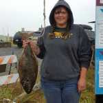 Keri Phillips of Newcastle, WY won $100 for the 2013 tagged fish she caught on July 22.