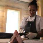 Aisha Ibrahim, Tutka Bay Lodge's chef for the 2016 summer season, demonstrates how to filet a salmon in The Tutka Bay Cooking School. Tutka Bay offers cooking classes held on the Widgin II. a repurposed crabbing boat on the lodge's property.-Photo by Anna Frost, Homer News
