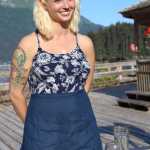 Chelsea Gunn, cooking instructor at Tutka Bay Lodge, explains the menu of a family-style dinner to lodge guests. -Photo by Anna Frost, Homer News