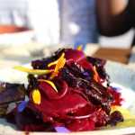 A beet salad with creme fraiche and garnished with flower petals is one of the dishes featuring local produce that the culinary staff at Tutka Bay Lodge create.-Photo by Anna Frost, Homer News