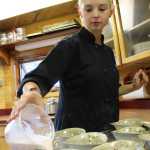 Chelsea Gunn pours rose panna cotta into bowls to chill and set before a cooking class at Tutka Bay Lodge. Gunn, a cooking instructor at the lodge, will serve the panna cotta as a dessert to the guests.-Photo by Anna Frost, Homer News
