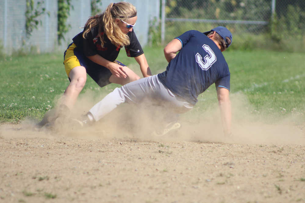 Mean Machine player Hannah Gordon tags out Joel Pietsch during the first championship game of the Homer city league tournament on Sunday, July 31.