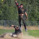 Mean Machine shortstop Danny Stanislaw leaps to catch the ball as he tries to get Beluga Lake Lodge player and coach Philip Jones out at second during the second game in the Homer city league tournament on Sunday, July 31.
