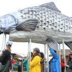 Participants in Salmonfest's King Sam parade carried a giant salmon puppet throughout the festival grounds, followed by a procession of people celebrating the fish.