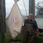 Daniel Spies shows off his 251-pound derby leading halibut on Aug. 11.