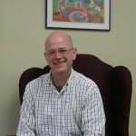 Todd Hindman sits in an armchair in Fireweed Academy's Little Fireweed building on Pioneer Avenue. HIndman has a history of working in schools with project-based programs similar to Homer's charter school.