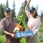 Paul and Jen Castellani of Will Grow Farm stand in their large garden plot with a cornucopia of their fresh vegetables and cheer as they are declared Kachemak Heritage Land Trust's second King Maker. The King Maker award celebrates individuals who do their part to help keep salmon habitats safe.