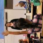 8:56 a.m.: Anne Love looks for a student to call on as the class does an exercise that helps the kids memorize facts about their class. While the students were at their desks, Love also talked about how to behave while they listen to her or other students talk.