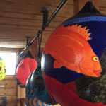 Decorated buoys on display at Alice's Champagne Palace will be auctioned off during the Homer Halibut Festival.