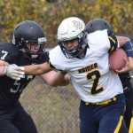 Homer quarterback Jaime Rios stiff arms Nikiski lineman Tyler Litke Saturday at Nikiski High School.