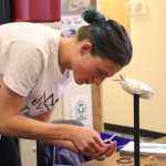 Justice Steiner picks up dyed porcupine quills as he works on his art piece during the Objects of Importane workshop at Homer Flex on Sept. 9. Artist Melissa Shaginoff brought in materials used in indigenous art for the students to work with.