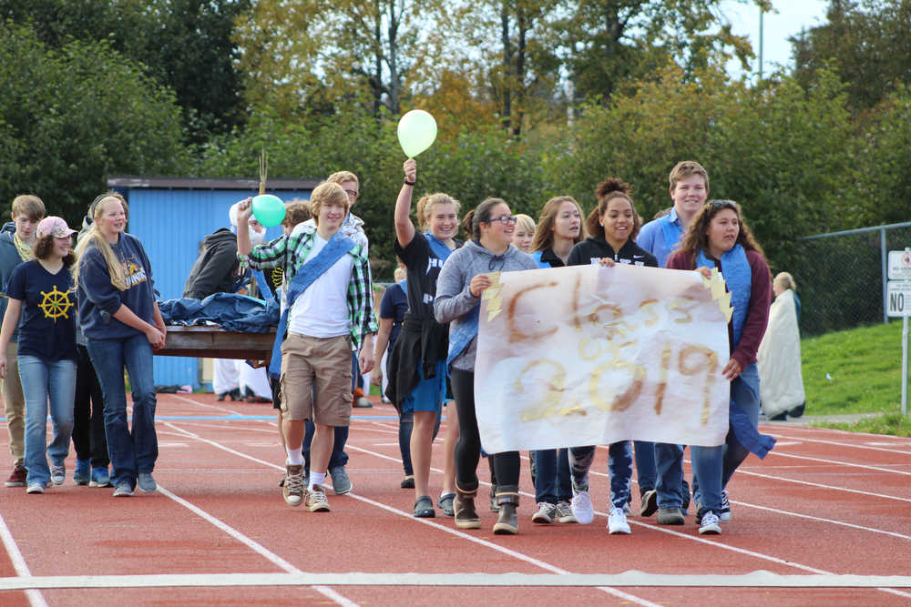 The sophomore class of Homer High School carries their Ancient Greece-themed float in the Parade of Classes during the Mariners' homecoming game on Saturday, Sept. 24.