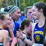 Photo by Joey Klecka/Peninsula Clarion Homer coach Bill Steyer (center) congratulates his girls team for winning the 1-2-3A championship Saturday at the Bartlett High School trails, as Megan Pitzman (570) talks to teammate Autumn Daigle.