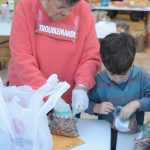 Kaye Fariday helps a student from Fireweed Academy bag food at the Homer Food Pantry on Sept. 26 at Homer United Methodist Church.