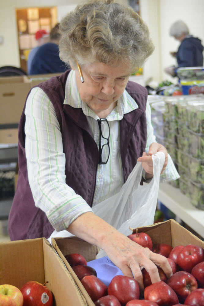 Diana Jeska bags apples at the Homer Food Pantry on Sept. 26 at Homer United Methodist Church.