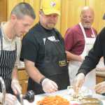 Rich Evanco, Ron Brahm, Tim Steinberg and Michael E. Gradney Jr. work in the kitchen at the Homer Food Pantry on Sept. 26 at Homer United Methodist Church.