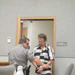 Homer Police Department Community Jail Officer Rick Pitta brings John Suter into the Homer District Courthouse for s his arraignment on Friday morning, Oct. 7.