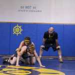 Homer High School head wrestling coach Chris Perk referees a practice match between Cole Bernier and Damian Kerr. The Mariner wrestling team has their first match of the season on Saturday, Oct. 15 in Kenai.