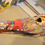 Some of the recycled box masks made by Claudio Orso-Giacone in a workshop at Bunnell Street Arts Center last month.