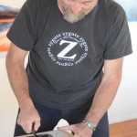 Claudio Orso-Giacone prepares a wood block to make a print during his residency at Bunnell Street Arts Center last month. He used a printing press donated to Bunnell by the estate of the Homer artist Gaye Wolfe.
