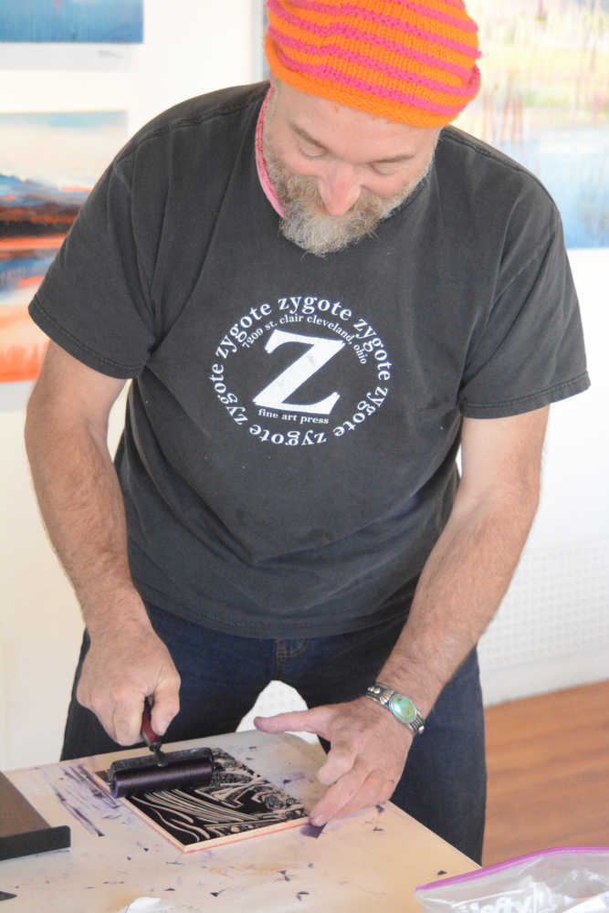 Claudio Orso-Giacone prepares a wood block to make a print during his residency at Bunnell Street Arts Center last month. He used a printing press donated to Bunnell by the estate of the Homer artist Gaye Wolfe.