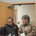 Homer Police Community Jail Officer Rick Pitta brings Lee John Henry into the Homer Courtroom for his arraignment on Monday. Henry was charged with first-degree murder in the July 2013 death of Mark Matthew in Homer.